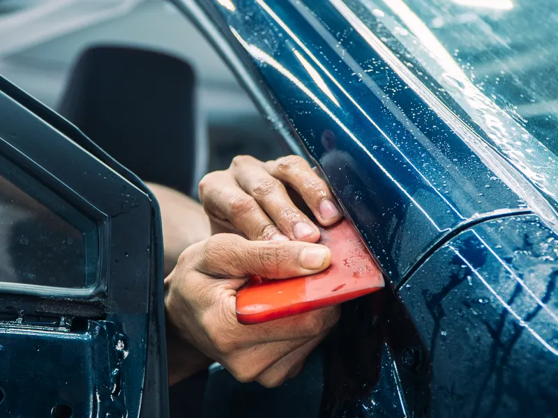 Applying protection film on a car door – surface protection application