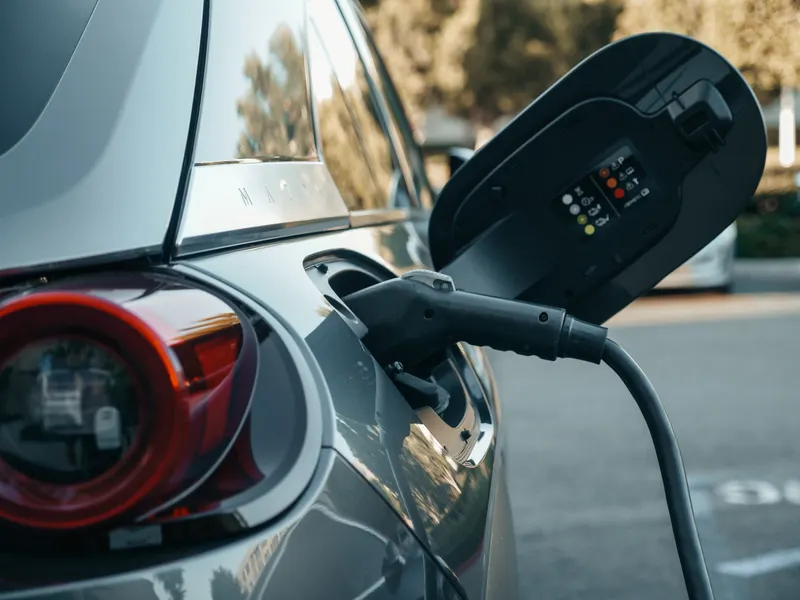 Charging plug connected to an electric vehicle – EV industry